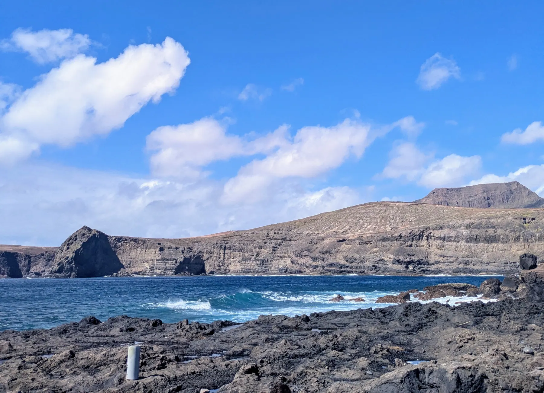 Dark volcanic rocks, ocean waves and cliffs close to Agaete's natural pools