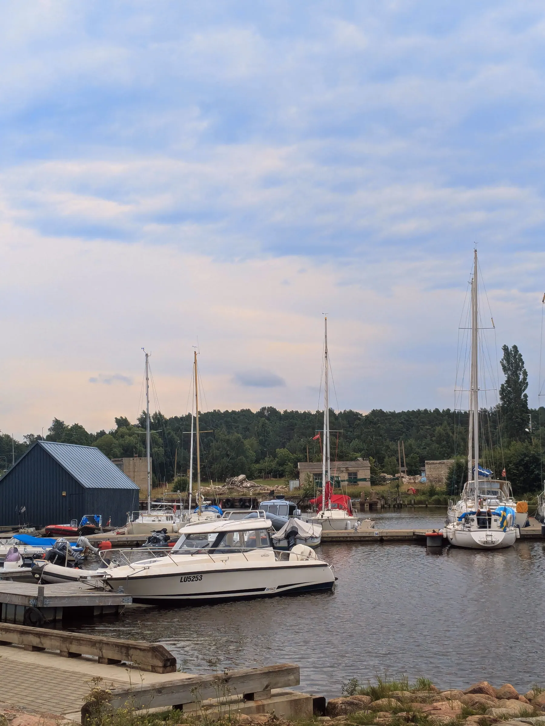 Sailing boats moored in the small harbour at Pāvilosta