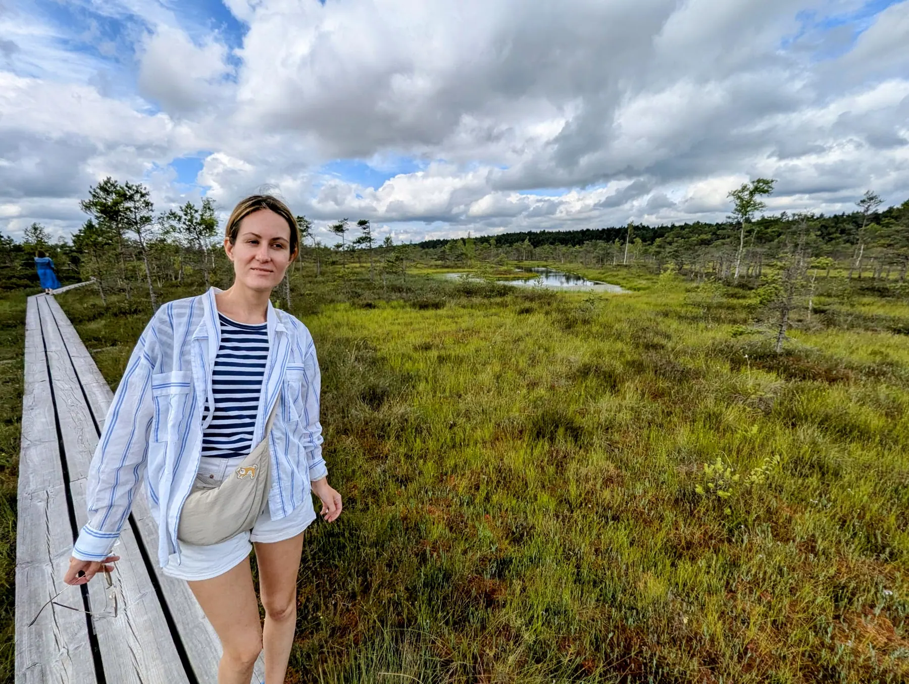 A visitor standing on the boardwalk in the Great Ķemeri Bog