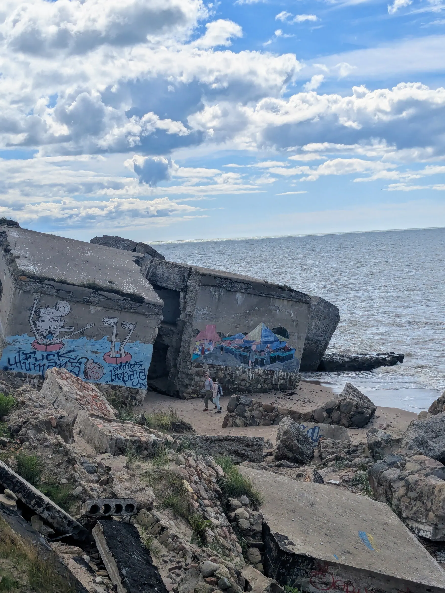 Broken concrete slabs of the Northern Forts scattered along the shoreline