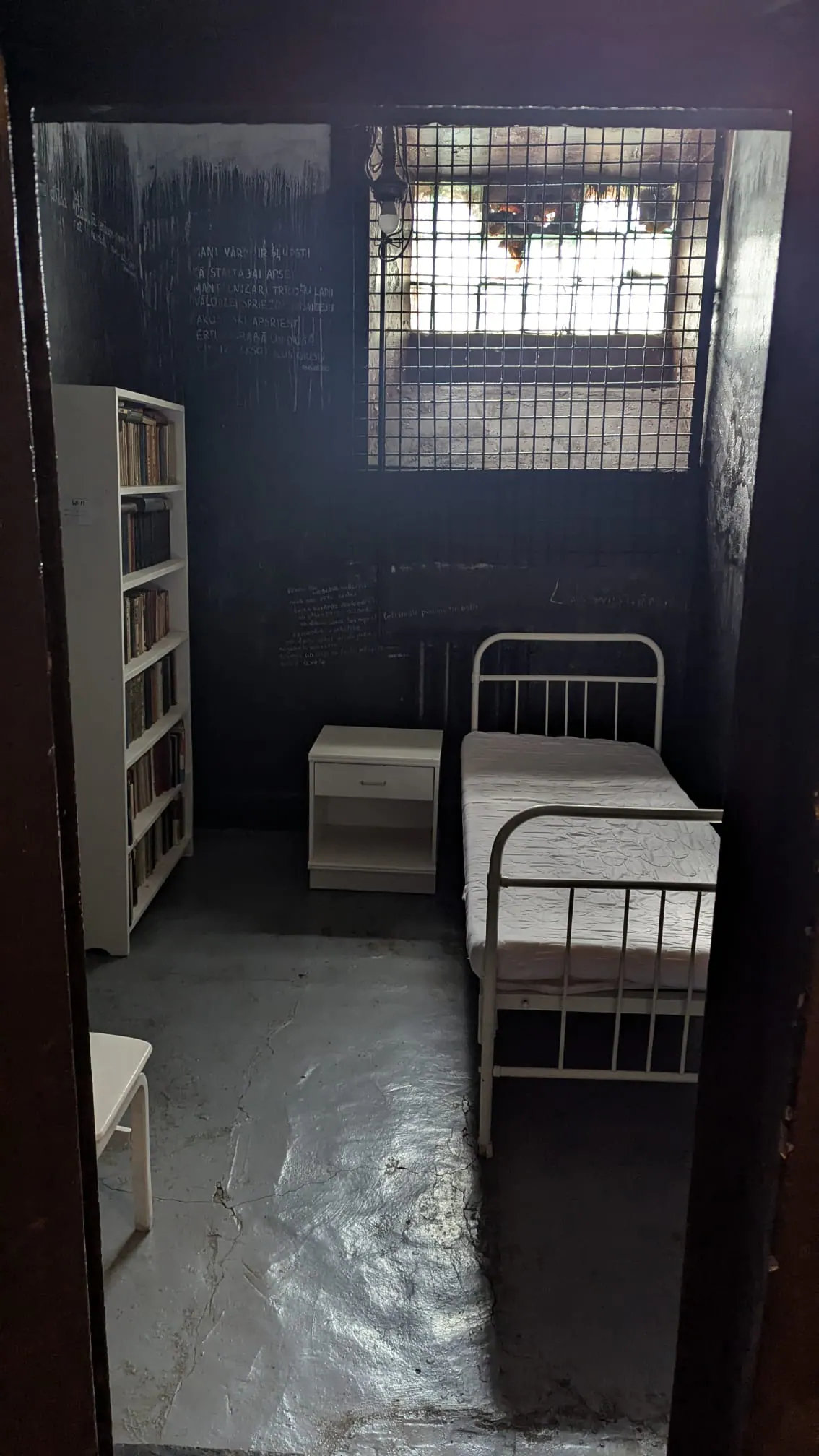 A stark Karosta Prison cell with two metal beds