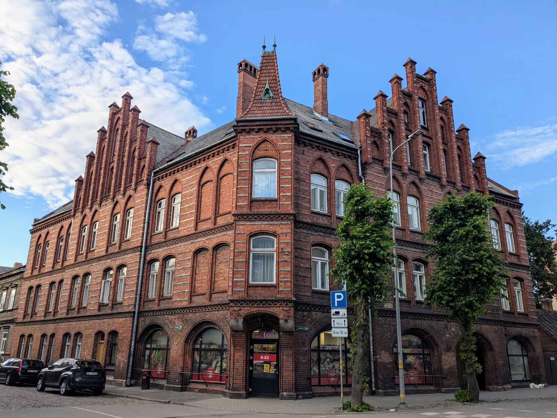 An ornate red-brick building along Peldu iela in Liepāja