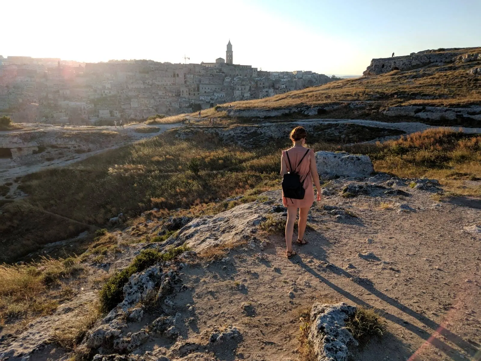 A traveler looking over Matera from the Murgia