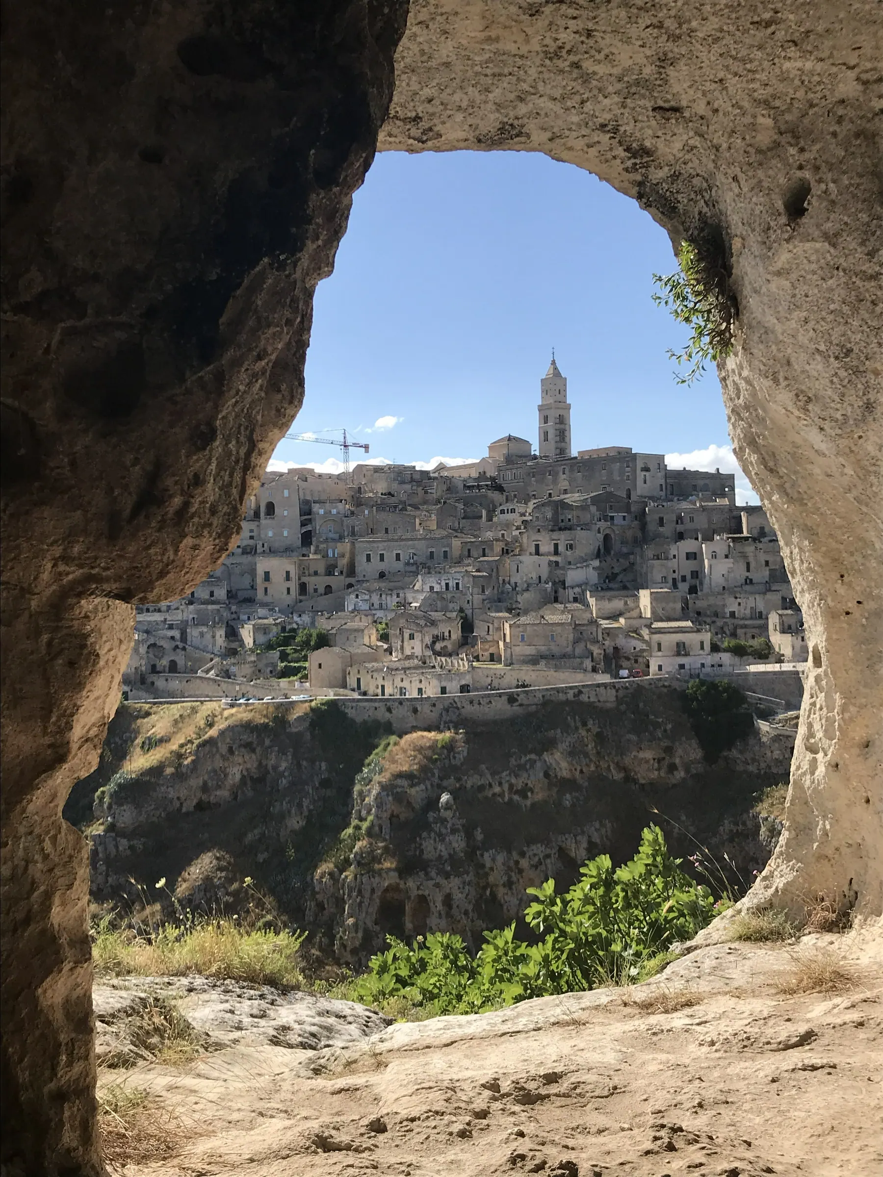 Matera framed by a cave window in the Murgia